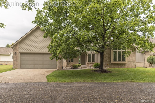 3145 Point Of The Woods Dr, West Bloomfield, MI 48324 - view of front of property featuring brick siding, driveway, an attached garage, and a front yard