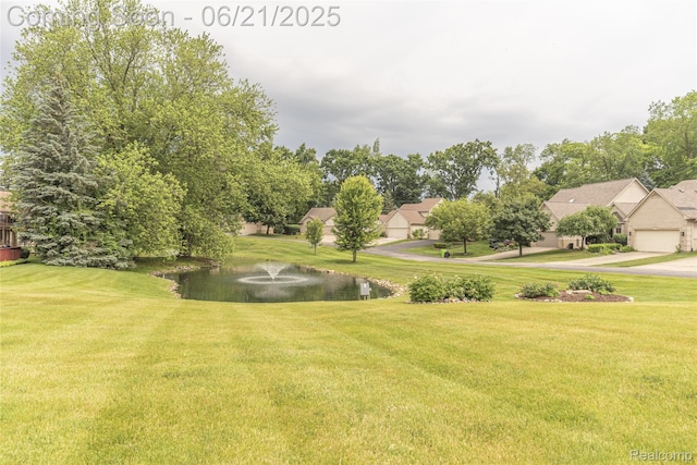 3145 Point Of The Woods Dr, West Bloomfield, MI 48324 - view of green lawn featuring a water view and driveway