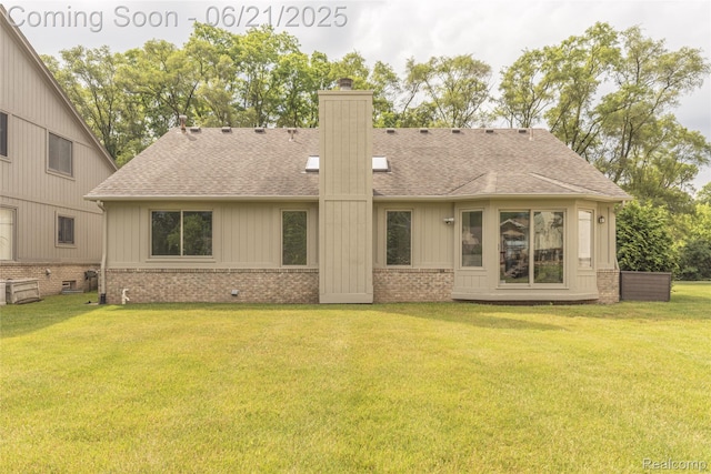 3145 Point Of The Woods Dr, West Bloomfield, MI 48324 - back of property with brick siding, a chimney, a yard, and roof with shingles