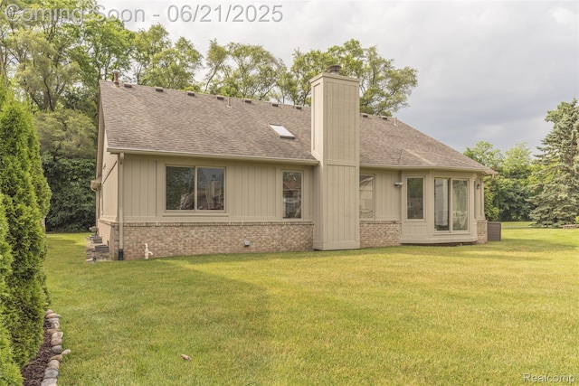 3145 Point Of The Woods Dr, West Bloomfield, MI 48324 - rear view of property with a chimney, a shingled roof, a yard, and brick siding
