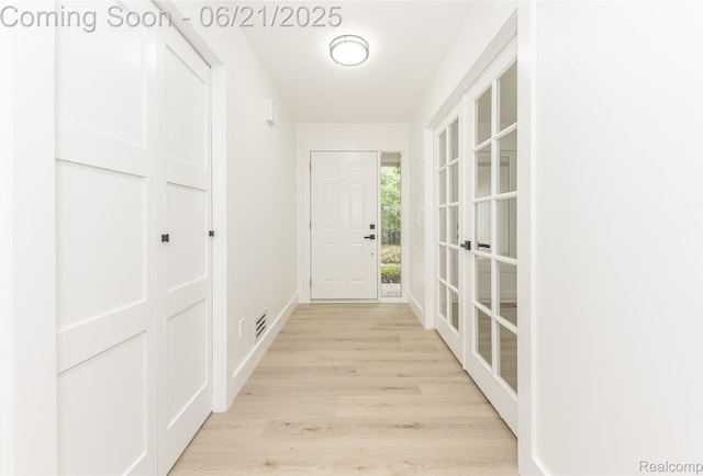 3145 Point Of The Woods Dr, West Bloomfield, MI 48324 - hallway with light wood-type flooring and french doors