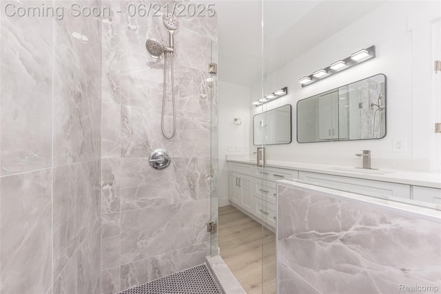 3145 Point Of The Woods Dr, West Bloomfield, MI 48324 - full bathroom with tiled shower, double vanity, and wood finished floors
