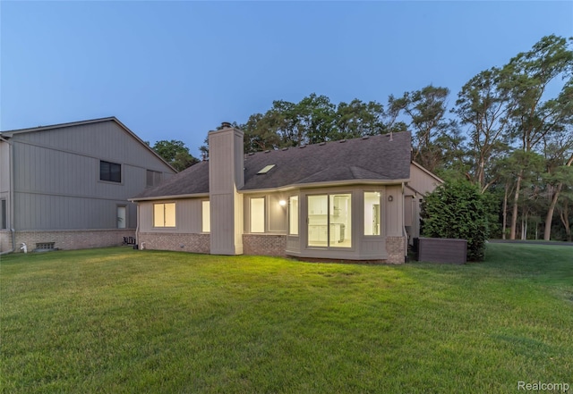 3145 Point Of The Woods Dr, West Bloomfield, MI 48324 - back of house featuring brick siding, a lawn, a chimney, and a shingled roof