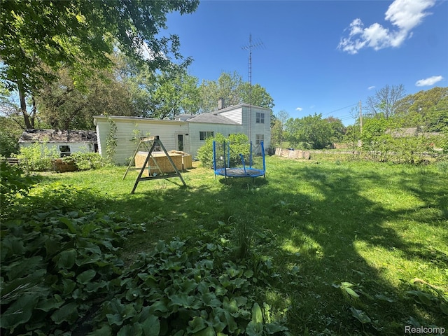 454 E Atherton Rd, Flint, MI 48507 - view of green lawn with a trampoline