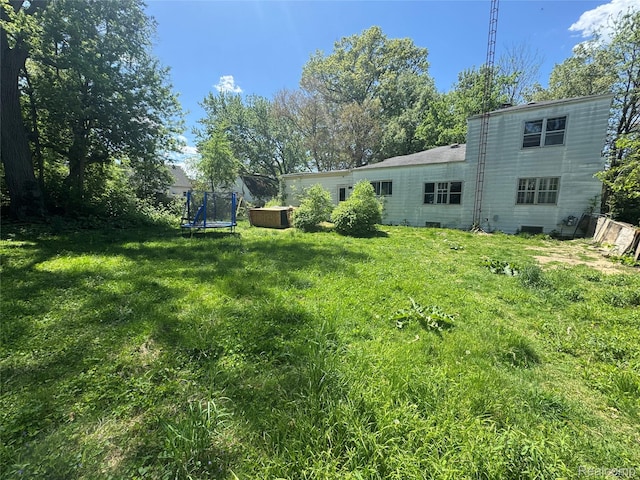 454 E Atherton Rd, Flint, MI 48507 - view of grassy yard with a trampoline