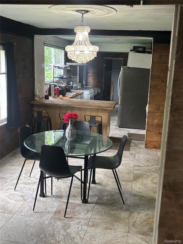 454 E Atherton Rd, Flint, MI 48507 - dining room with plenty of natural light, stone finish floors, and a chandelier