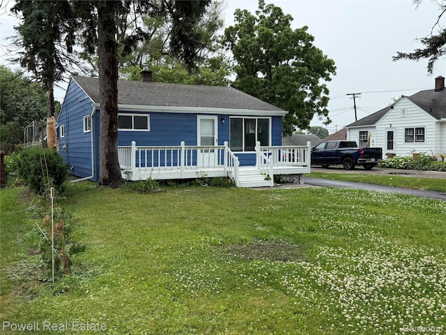 2326 Silver Cir, Pontiac, MI 48328 - view of front of house with a wooden deck, a chimney, a front yard, and a shingled roof