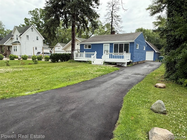 2326 Silver Cir, Pontiac, MI 48328 - view of front facade featuring a front yard, a chimney, a wooden deck, and a garage