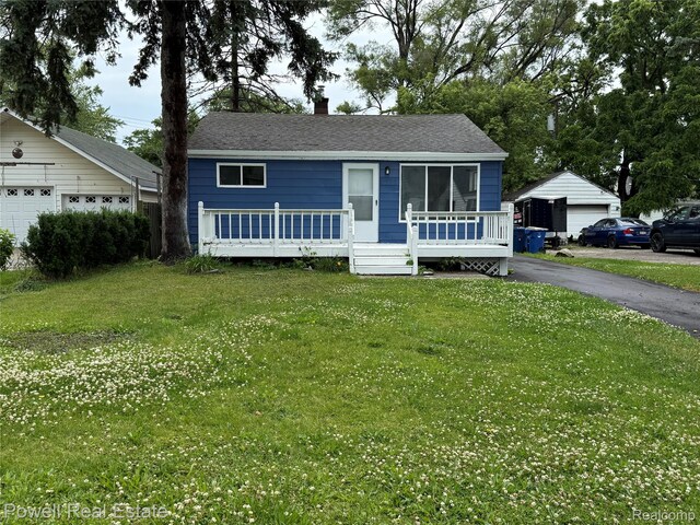 2326 Silver Cir, Pontiac, MI 48328 - view of front of home featuring a garage, a front yard, and a chimney