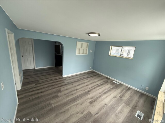 2326 Silver Cir, Pontiac, MI 48328 - spare room with arched walkways and wood finished floors