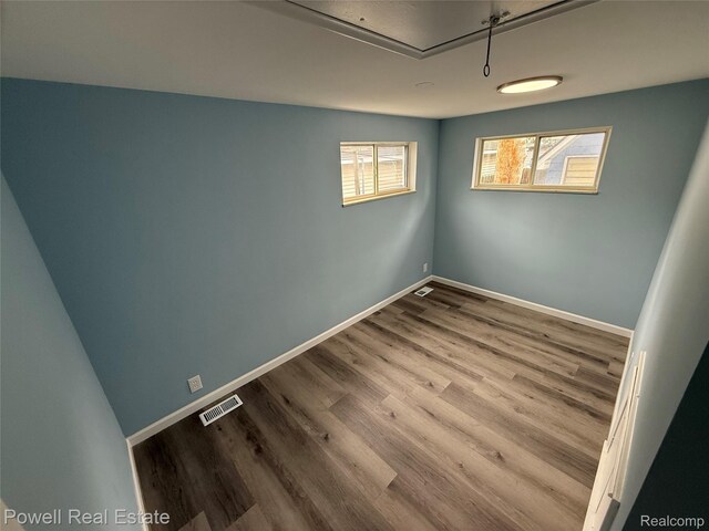 2326 Silver Cir, Pontiac, MI 48328 - empty room with wood finished floors and attic access
