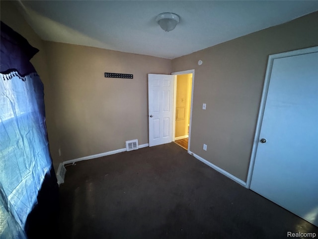 17370 Stout St, Detroit, MI 48219 - unfurnished bedroom with baseboards and dark carpet