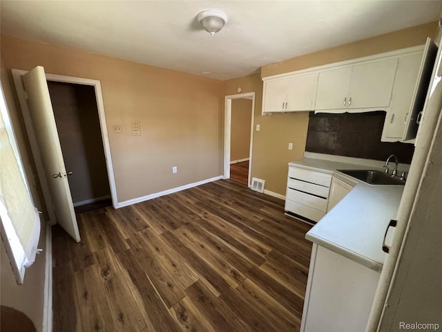 17370 Stout St, Detroit, MI 48219 - kitchen with dark wood-type flooring, white cabinetry, and light countertops