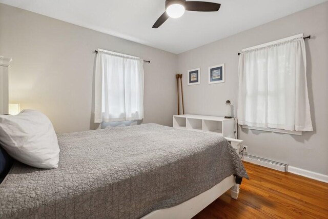 13176 Red Arrow Hwy, Sawyer, MI 49125 - bedroom with a baseboard radiator, wood finished floors, and ceiling fan