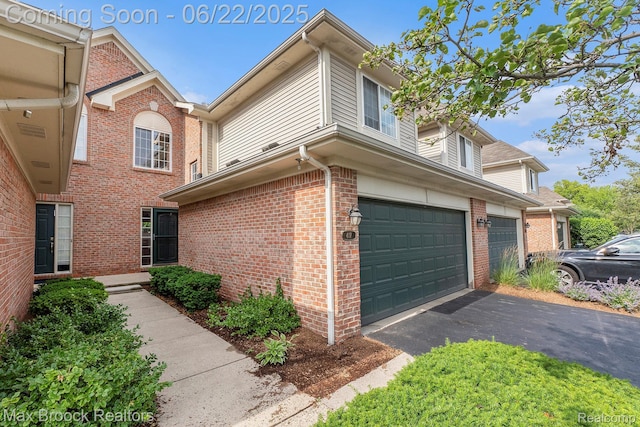 417 James Cir, Royal Oak, MI 48067 - view of side of home with a garage, driveway, and brick siding