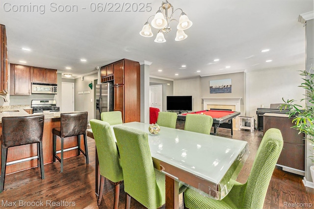 417 James Cir, Royal Oak, MI 48067 - dining room featuring a fireplace, dark wood-type flooring, ornamental molding, recessed lighting, and a chandelier