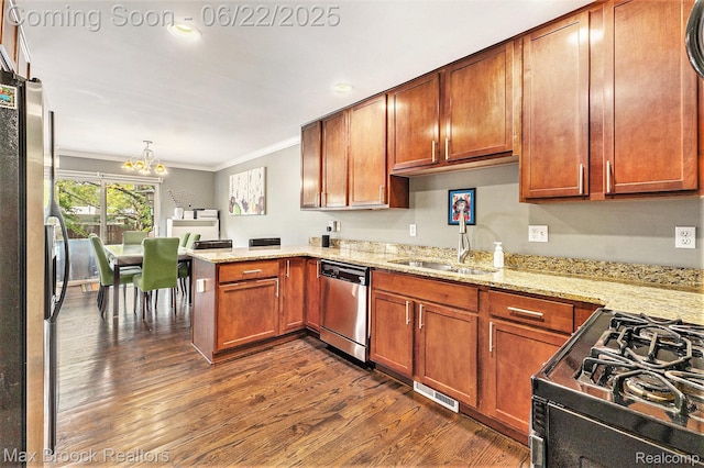 417 James Cir, Royal Oak, MI 48067 - kitchen with stainless steel appliances, crown molding, dark wood-type flooring, a peninsula, and a chandelier