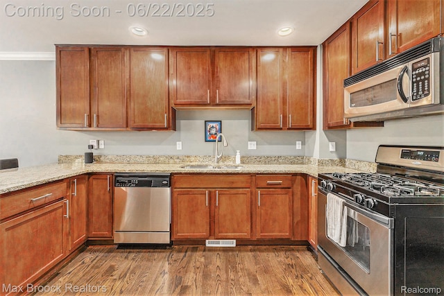 417 James Cir, Royal Oak, MI 48067 - kitchen featuring stainless steel appliances, dark wood-type flooring, light stone counters, and recessed lighting