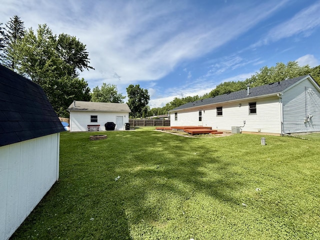 8021 Mclain Ave, Lambertville, MI 48144 - view of yard with an outdoor structure, a wooden deck, and an outdoor fire pit