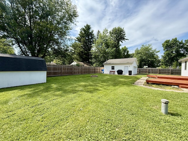 8021 Mclain Ave, Lambertville, MI 48144 - fenced backyard with a wooden deck, a storage shed, and a detached garage