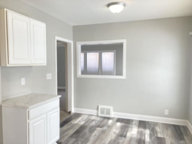 11751 Engleside St, Detroit, MI 48205 - unfurnished dining area with dark wood-style floors and baseboards