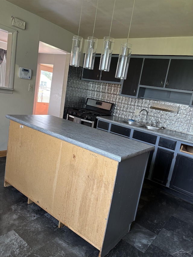 644 S 26th St, Saginaw, MI 48601 - kitchen featuring stainless steel range with gas cooktop, decorative backsplash, dark cabinets, and stone finish floors