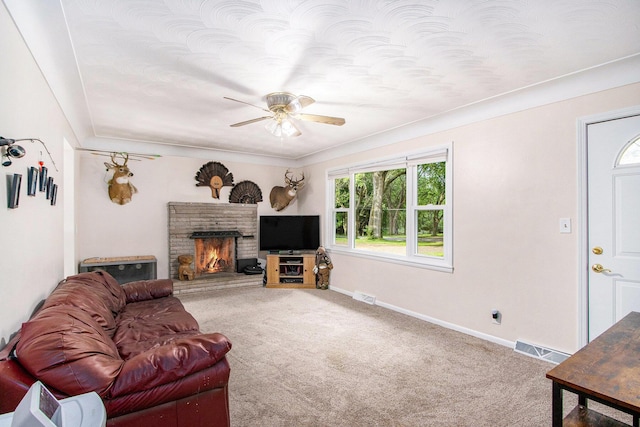9930 N 16th St, Plainwell, MI 49080 - living room with ceiling fan, carpet flooring, and a warm lit fireplace