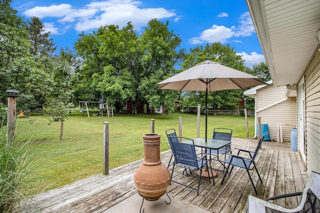 9930 N 16th St, Plainwell, MI 49080 - deck with outdoor dining space, a playground, and view of scattered trees