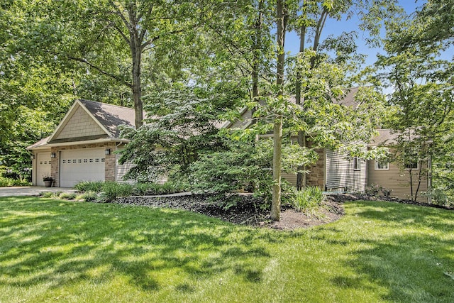 3314 Westview Ct, Allegan, MI 49010 - view of green lawn with a garage