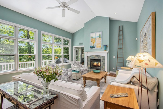 3314 Westview Ct, Allegan, MI 49010 - living room with a ceiling fan, plenty of natural light, a fireplace, wood finished floors, and high vaulted ceiling
