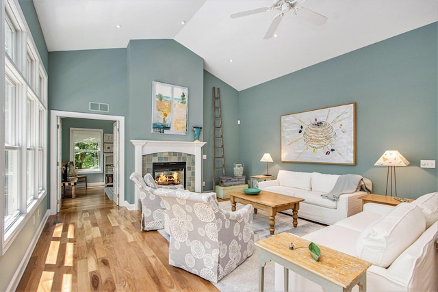 3314 Westview Ct, Allegan, MI 49010 - living area with light wood finished floors, high vaulted ceiling, a fireplace, and ceiling fan