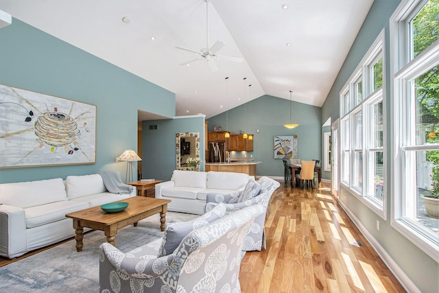 3314 Westview Ct, Allegan, MI 49010 - living area featuring light wood-style flooring, plenty of natural light, a ceiling fan, and high vaulted ceiling