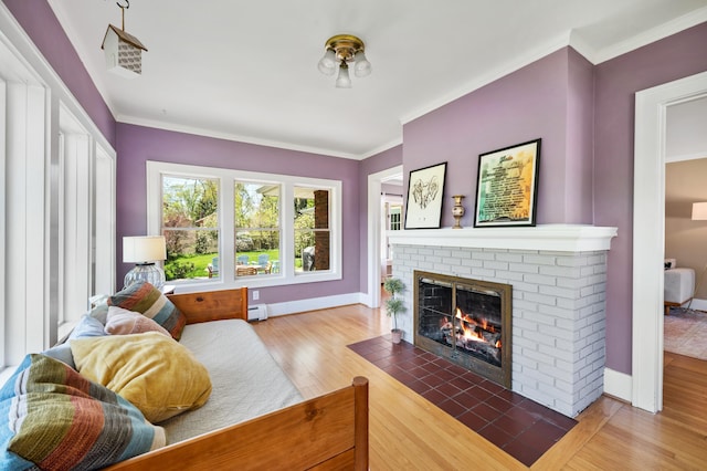 1908 Niles Ave, Saint Joseph, MI 49085 - living room featuring a fireplace, wood finished floors, a baseboard radiator, and crown molding