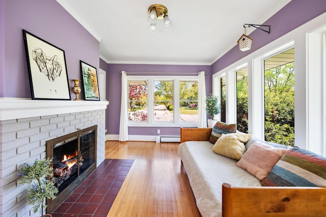 1908 Niles Ave, Saint Joseph, MI 49085 - living area with baseboard heating, a fireplace, ornamental molding, and hardwood / wood-style floors
