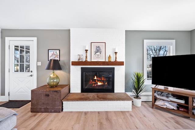 1908 Niles Ave, Saint Joseph, MI 49085 - living room with wood finished floors, a fireplace, and baseboard heating