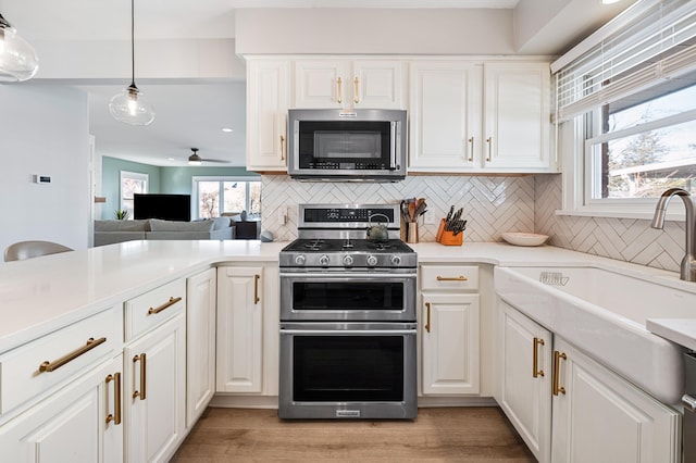 1908 Niles Ave, Saint Joseph, MI 49085 - kitchen featuring appliances with stainless steel finishes, backsplash, healthy amount of natural light, and light countertops