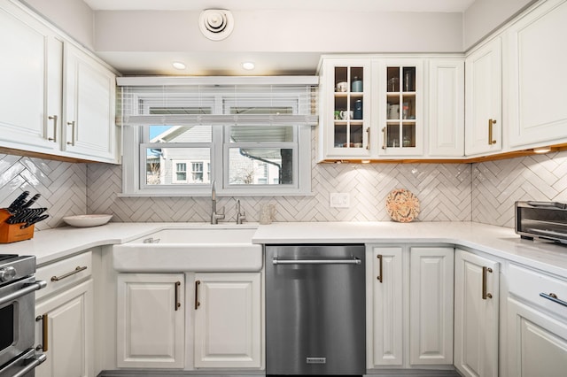 1908 Niles Ave, Saint Joseph, MI 49085 - kitchen with stainless steel dishwasher, range, white cabinetry, tasteful backsplash, and glass insert cabinets