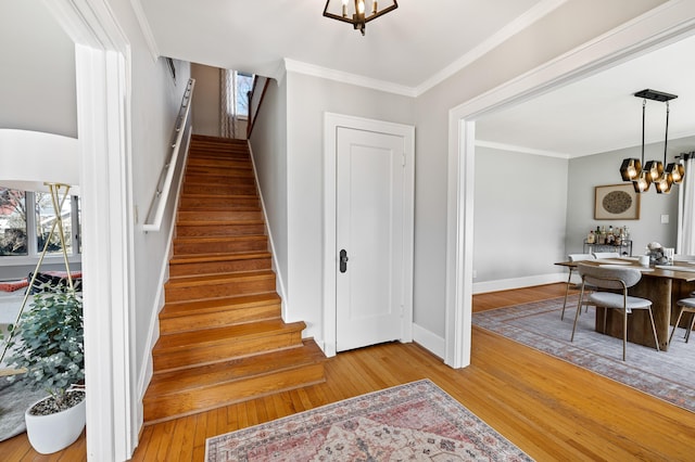 1908 Niles Ave, Saint Joseph, MI 49085 - stairs featuring a chandelier, wood-type flooring, and ornamental molding