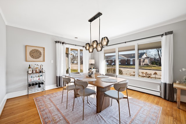 1908 Niles Ave, Saint Joseph, MI 49085 - dining area with a baseboard heating unit, crown molding, light wood finished floors, and a chandelier