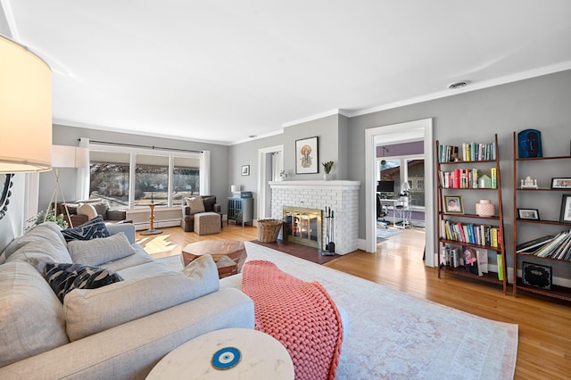 1908 Niles Ave, Saint Joseph, MI 49085 - living area with a fireplace, ornamental molding, wood finished floors, and a baseboard heating unit