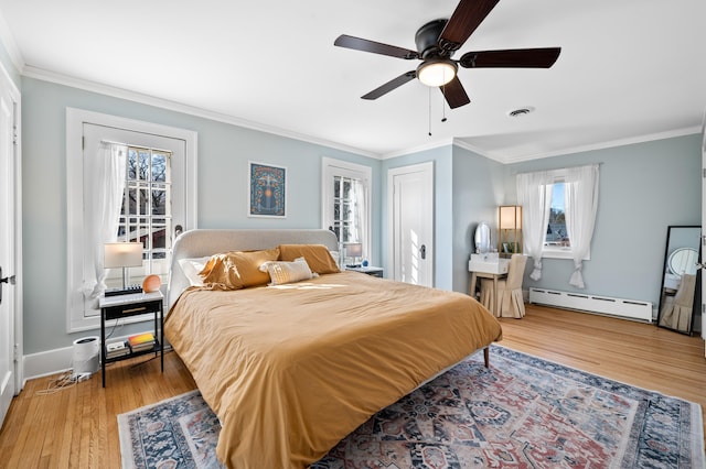 1908 Niles Ave, Saint Joseph, MI 49085 - bedroom featuring baseboard heating, wood finished floors, ornamental molding, and ceiling fan