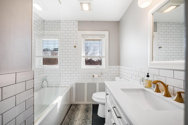 1908 Niles Ave, Saint Joseph, MI 49085 - bathroom with tile walls, vanity, tile patterned floors, radiator, and bathing tub / shower combination