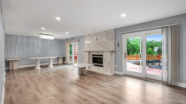 6596 Corral Ct, West Bloomfield, MI 48324 - unfurnished living room with recessed lighting, light wood-style floors, and a high end fireplace