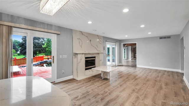 6596 Corral Ct, West Bloomfield, MI 48324 - living room featuring healthy amount of natural light, a high end fireplace, recessed lighting, and light wood-type flooring