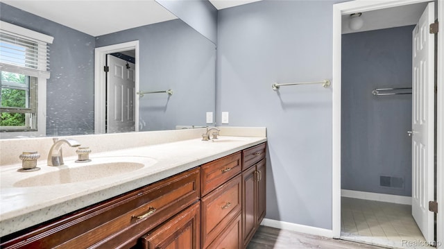 6596 Corral Ct, West Bloomfield, MI 48324 - bathroom with double vanity and baseboards