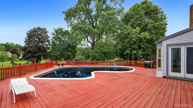 6596 Corral Ct, West Bloomfield, MI 48324 - view of swimming pool featuring a wooden deck and view of scattered trees