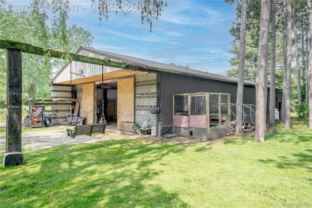 8780 Dixie Hwy, Birch Run, MI 48415 - rear view of property featuring an outdoor structure and concrete block siding