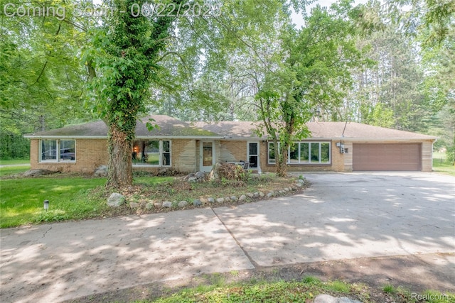 8780 Dixie Hwy, Birch Run, MI 48415 - single story home featuring concrete driveway, an attached garage, brick siding, and a front lawn