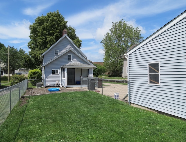 1513 Joy Ave, Jackson, MI 49203 - rear view of property with a fenced backyard and a chimney