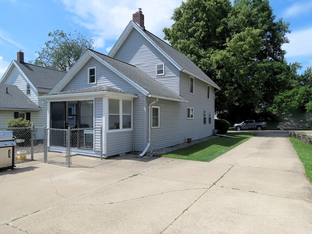 1513 Joy Ave, Jackson, MI 49203 - rear view of property featuring a gate, roof with shingles, and a chimney